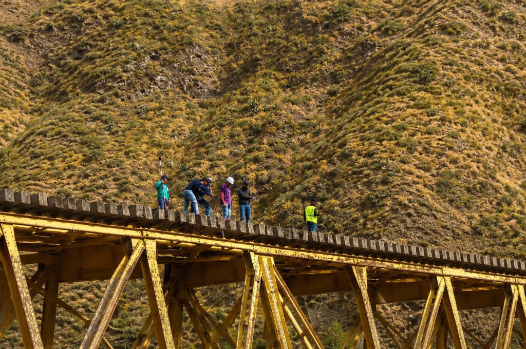 Trabajadores realizan labores de inspección y mantenimiento sobre uno de los puentes de la ruta ferroviaria Ibarra-Salinas, como parte del proceso previo a su rehabilitación y futura reapertura.